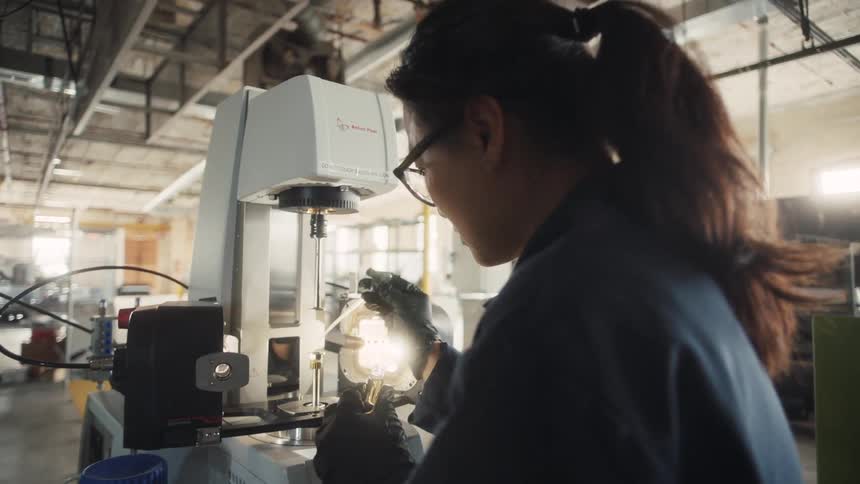 The woman puts a drop in the machine to test
