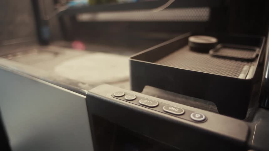 Closeup of control panel buttons on industrial equipment in a workshop setting