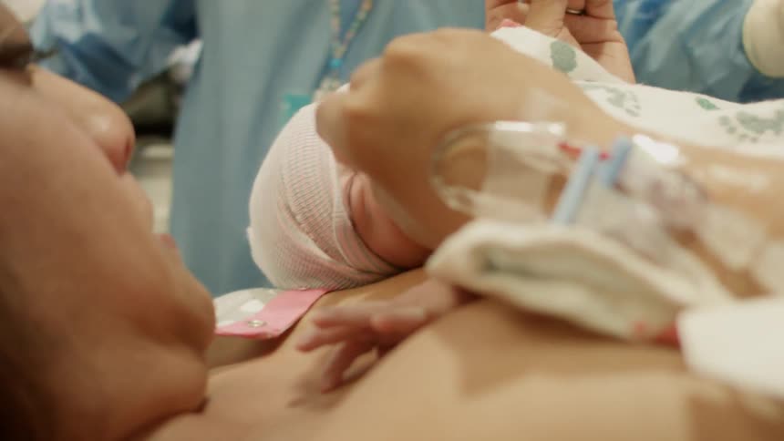 A woman holds her newborn