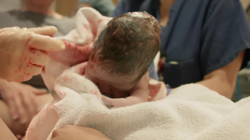 A doctor cleans off a newborn baby