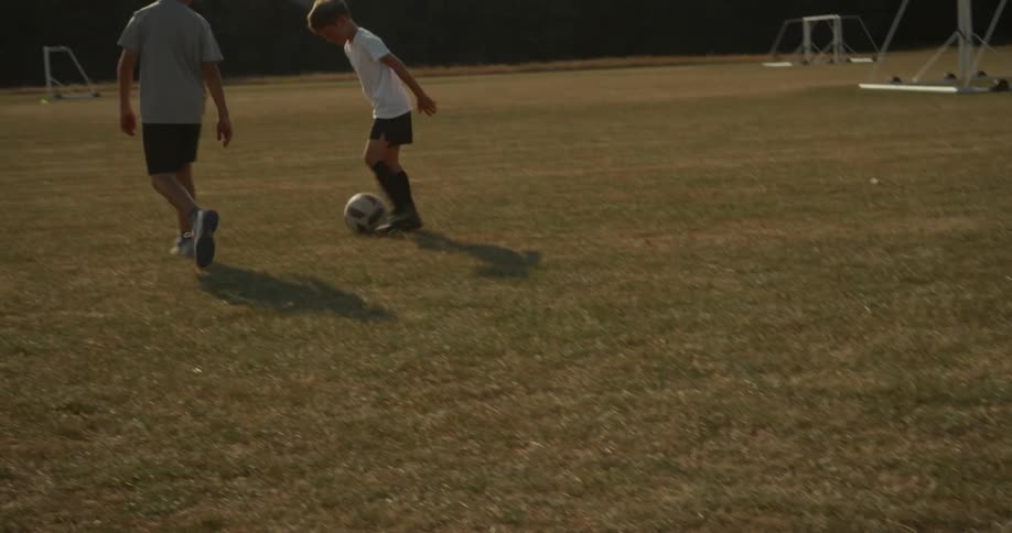 Children are kicking the soccer ball together