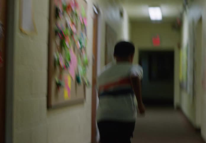 Boy running in a school hallway