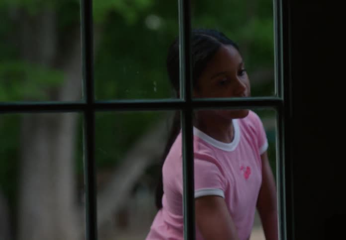 Girl opening the door of a residence and entering