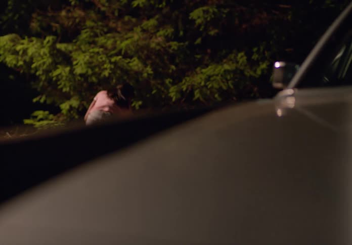 The girl tries to break the car window with a rock