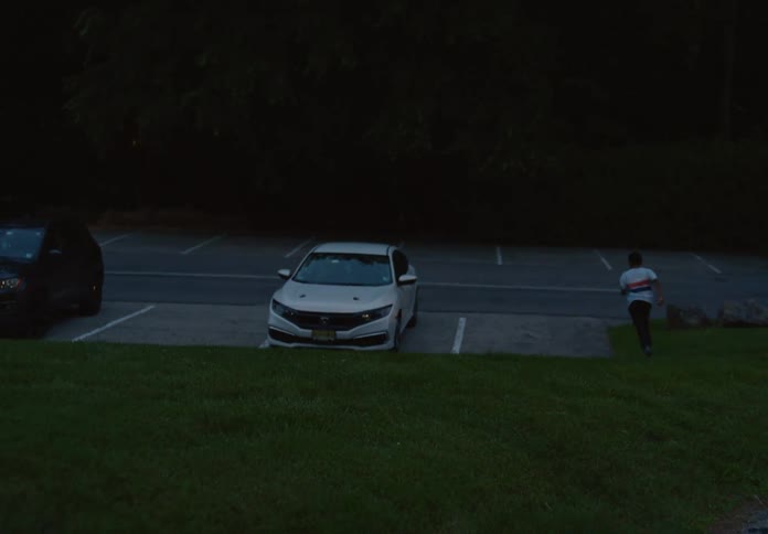 The boy runs into the parking lot
