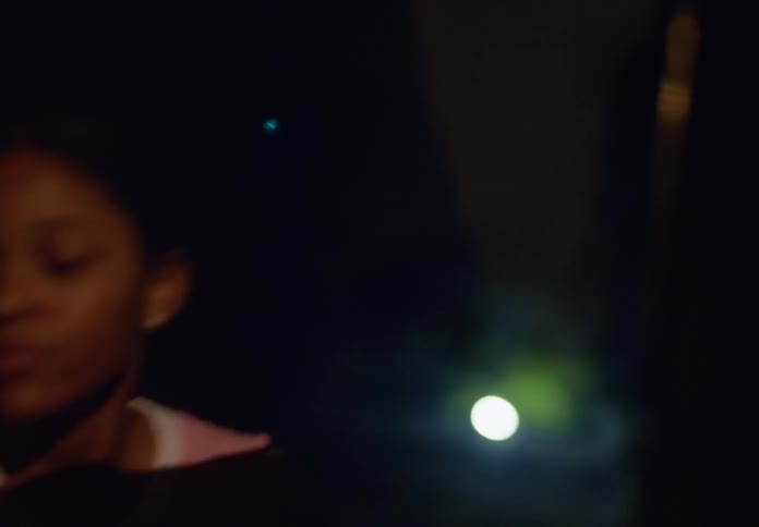 The girl runs around at night scared and trying to get in a car