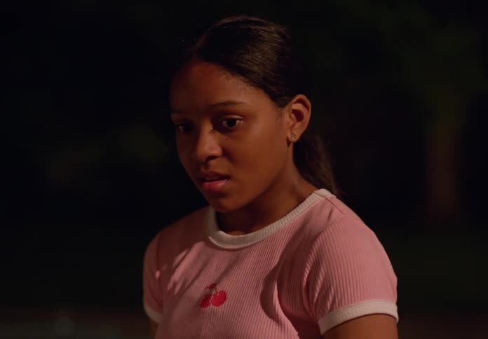 A girl runs up to the car looking worried
