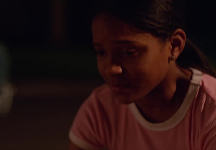 The girl is worried because a boy is injured on the ground