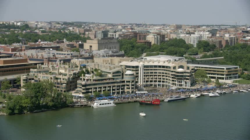 Buildings stand next to a river