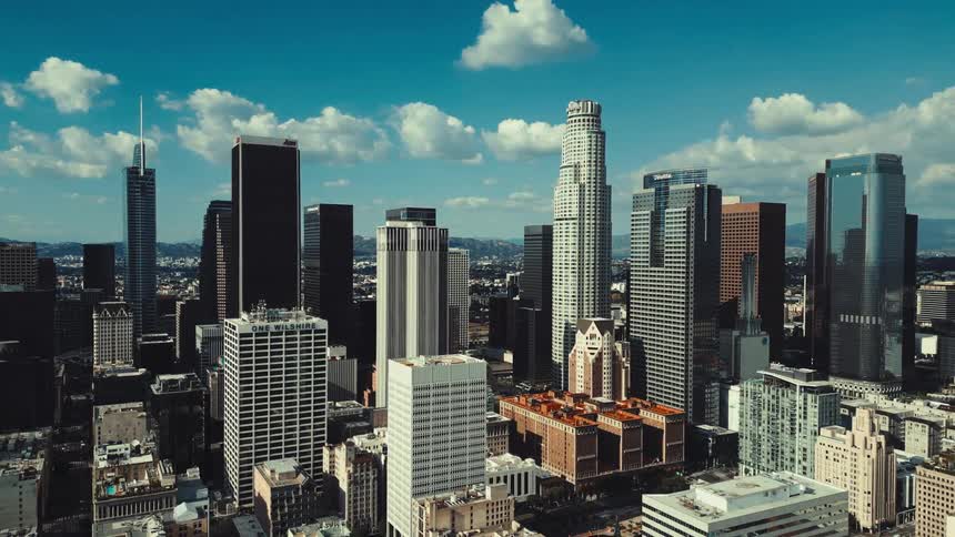 A timelapse of the los angeles skyline at night with city lights twinkling as cars zip by on the freeways the iconic wilshire grand center the tallest building in the city stands prominently among the other illuminated skyscrapers