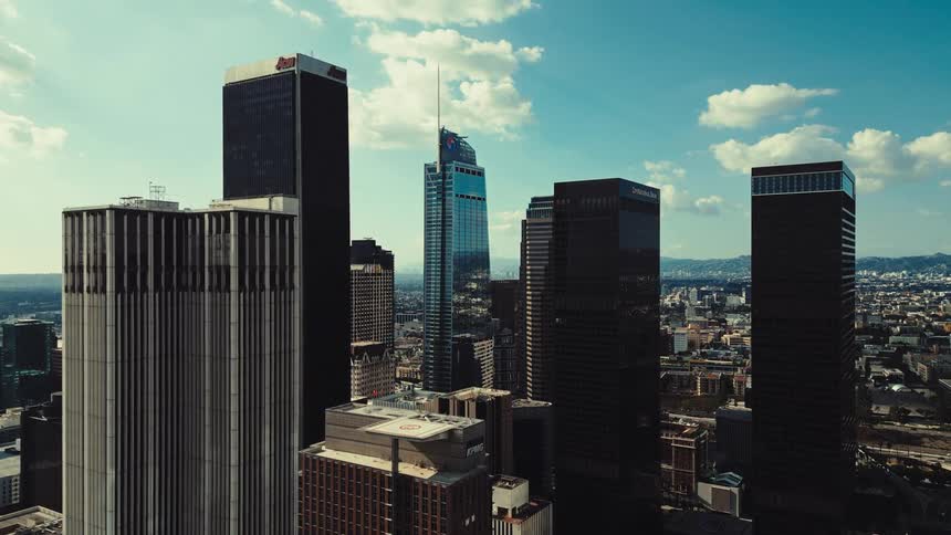 The tall towers are under a partially cloudy sky