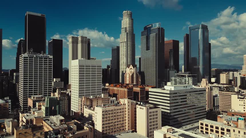 A city skyline view filled with tower blocks and skyscrapers at midday