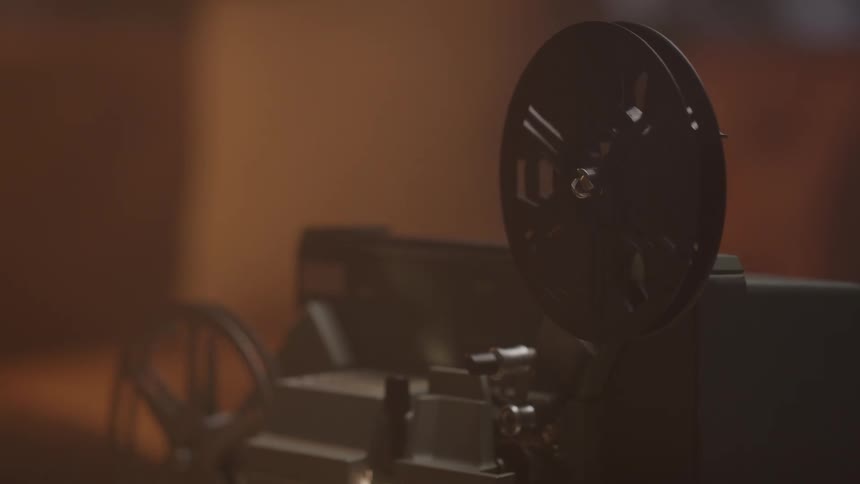 The reels of film spin in the projector