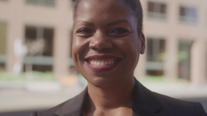 A woman smiles at the camera
