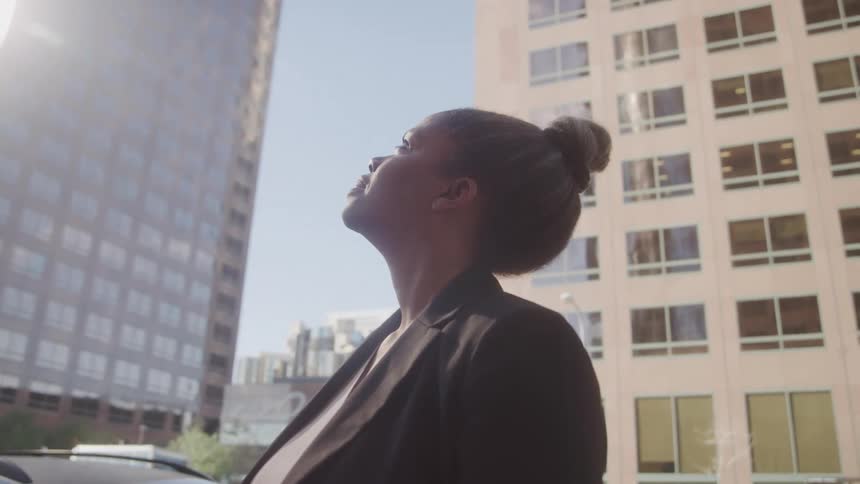 A woman stands in a city