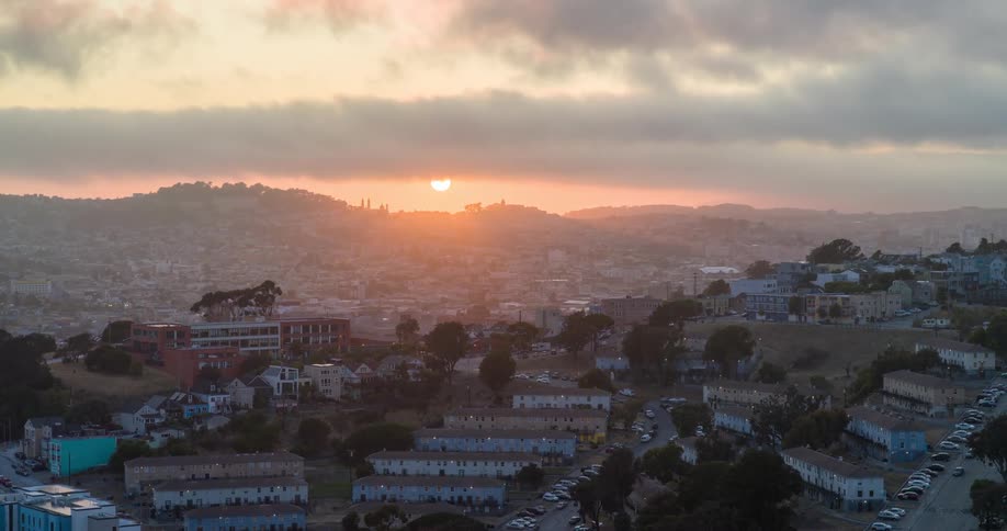 Urban landscape with houses on mountains with sunrise on the horizon