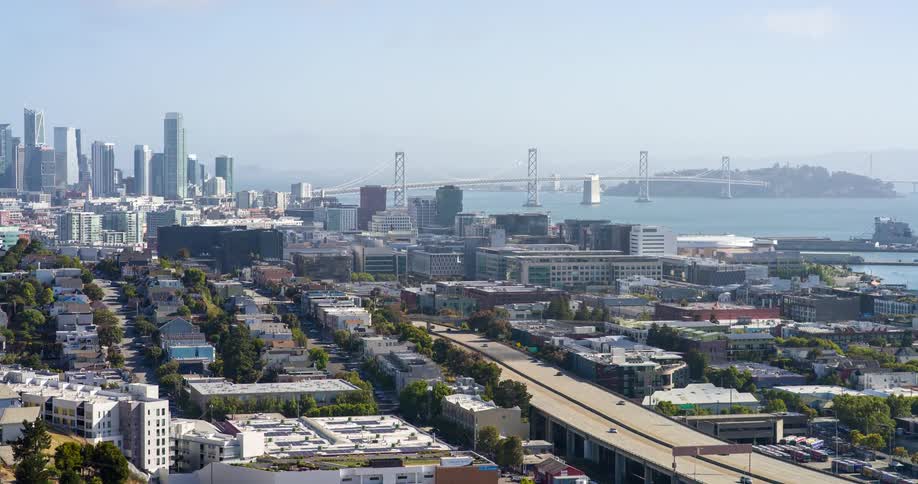 A highway leading into a city cars driving on it
