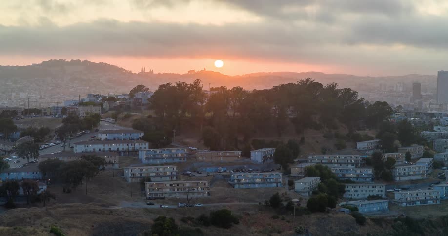 Aerial view of residential areas in mountains with sunrise on the horizon