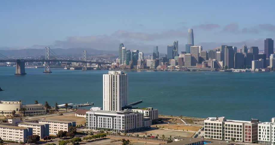 Panoramic view of the san francisco bay with the bridge on the left and downtown skyscrapers in the background