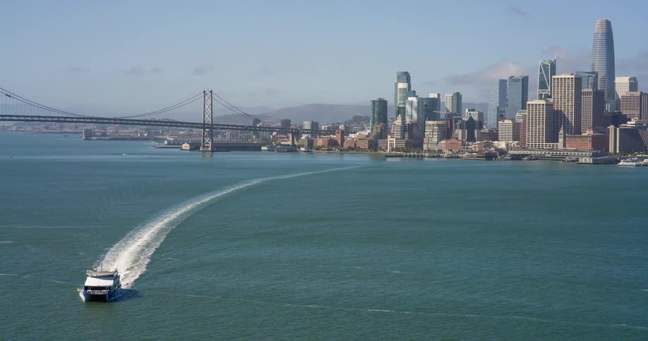 The boat is traveling away from the city