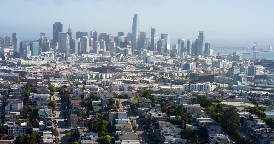 The suburbs before the city are in shade from the clouds