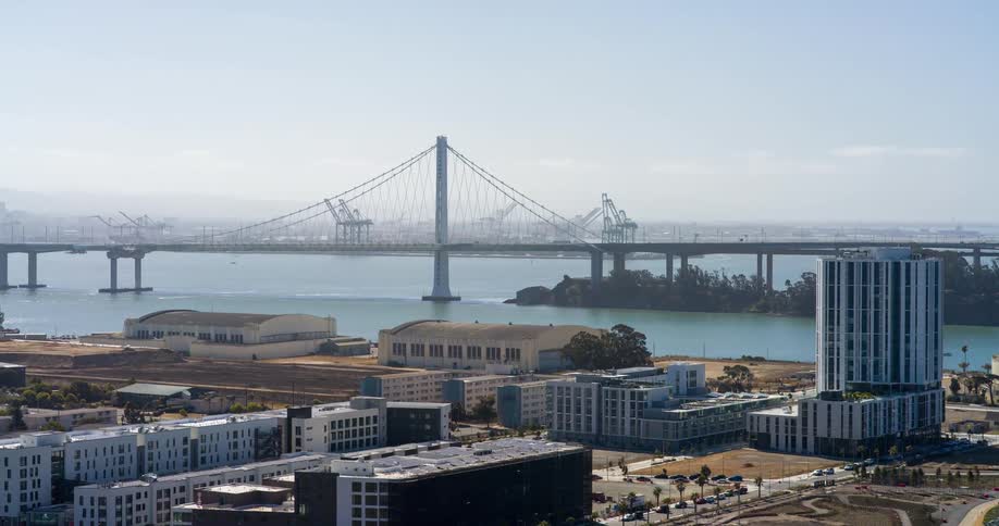 Urban city by the sea with a bridge in the background seen during the day