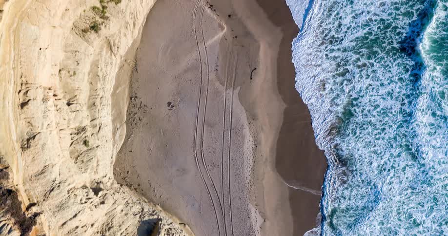 A tall cliff is on the beach