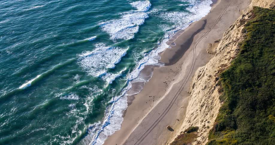 Waves crash against a beach