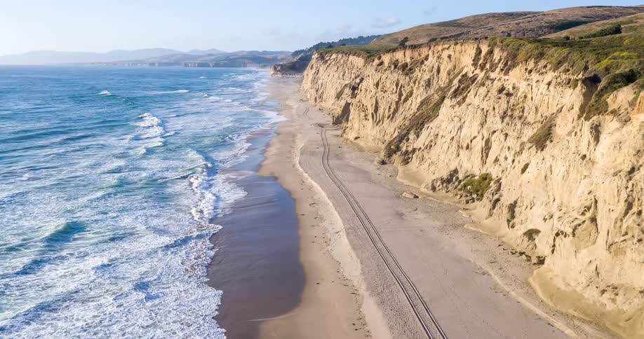 Cars travel on the coastal road