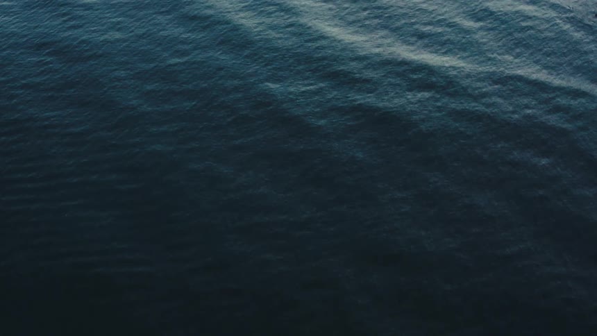 An ocean view with light waves caused by the wind at midday