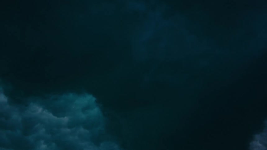 Underwater view of ocean wave crashing overhead
