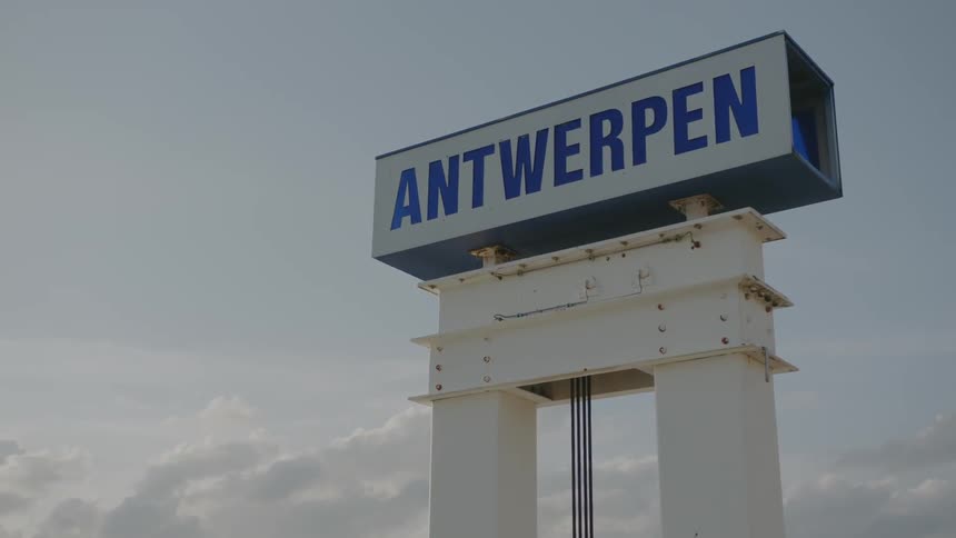 A blue and white sign on a cloudy day
