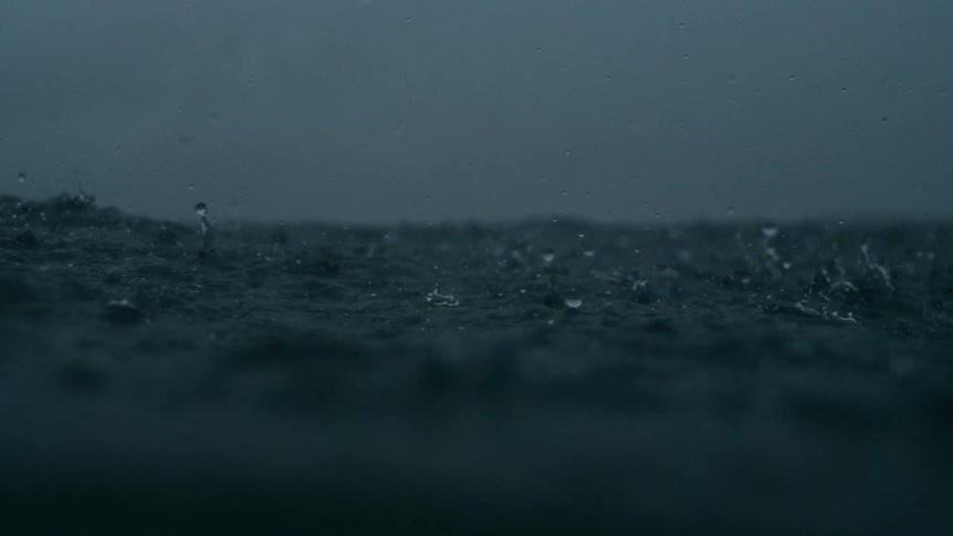 Slow motion of raindrops falling on to the surface of the ocean