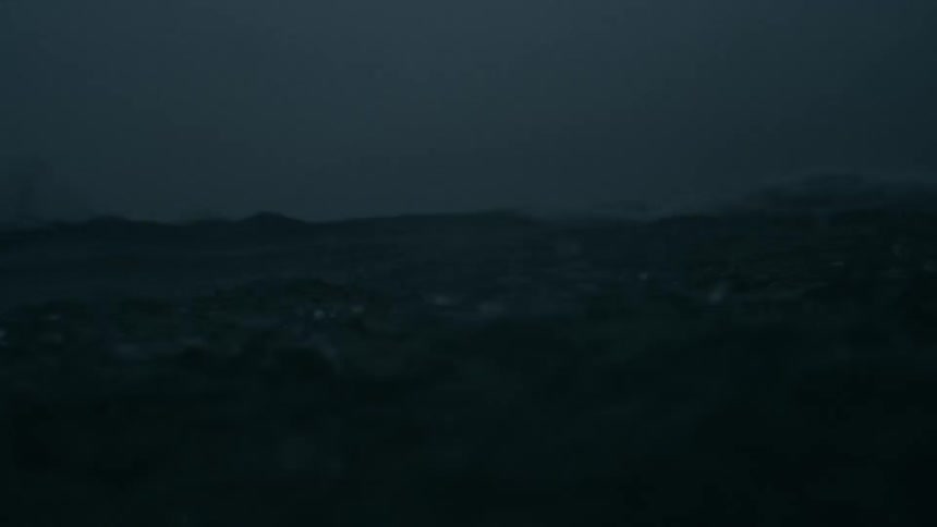 Rain falling into an ocean on a cloudy day