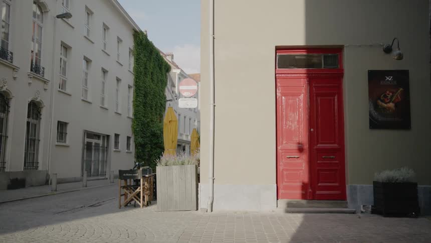 A bright red door sits at the front of a building
