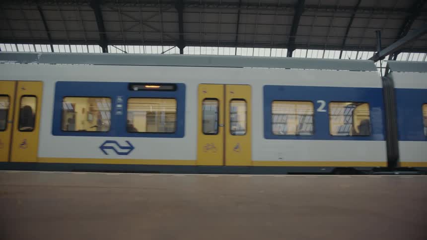 A subway train drives through a station