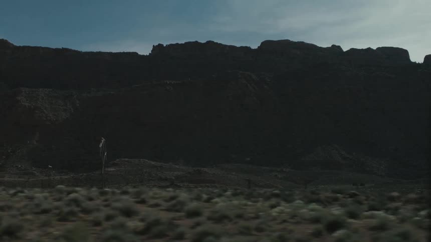 Mountains and desert seen from a traveling vehicle