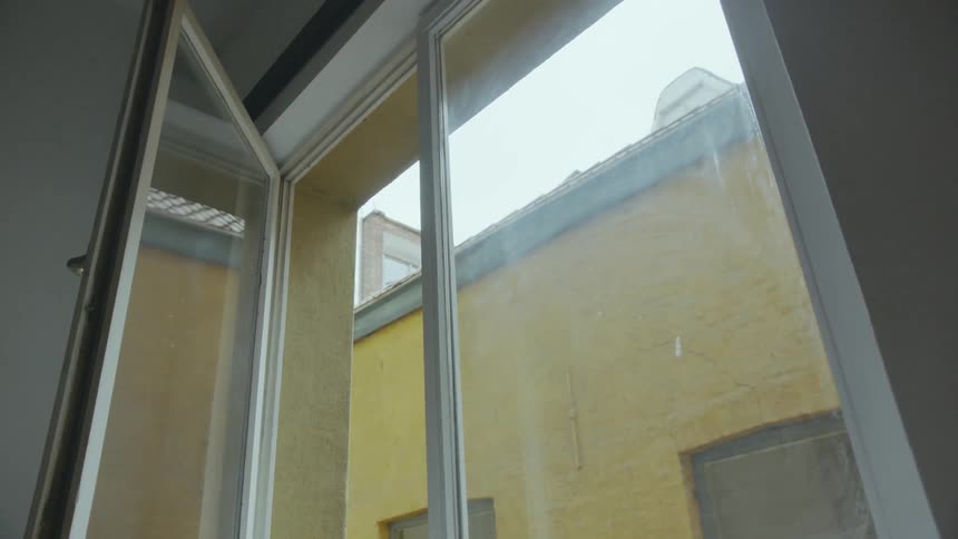 A bedroom window sits partially opened