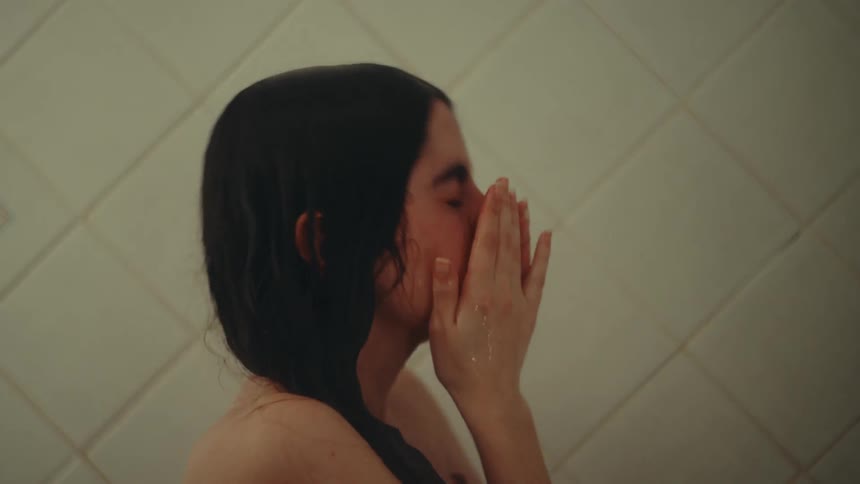 A woman is showering in the bathroom