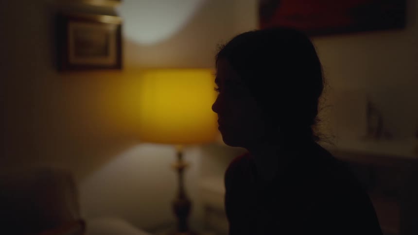 A girl is crying in the dark