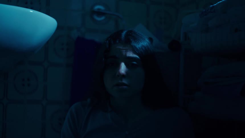 The girl looks scared in the bathroom