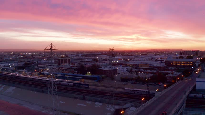 Aerial view of an urban city with the reddish sky of dawn
