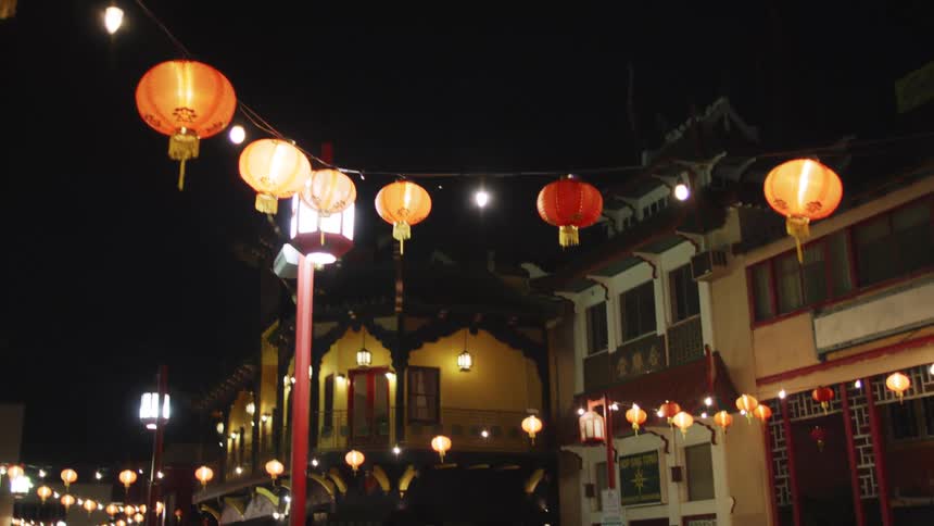 Asian balloons with lamps illuminating a suburban area at night
