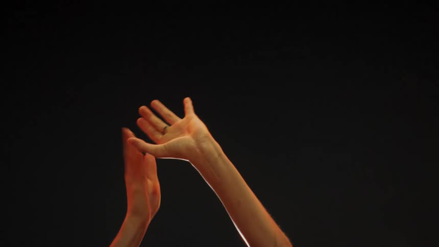 Dancing hands against a black backdrop