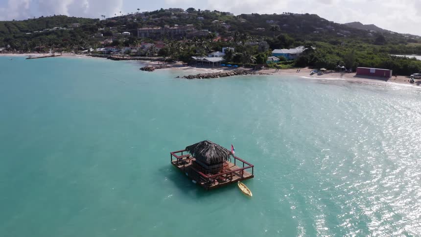 Panorama of a floating mobile cabin in the ocean with the coast in the background