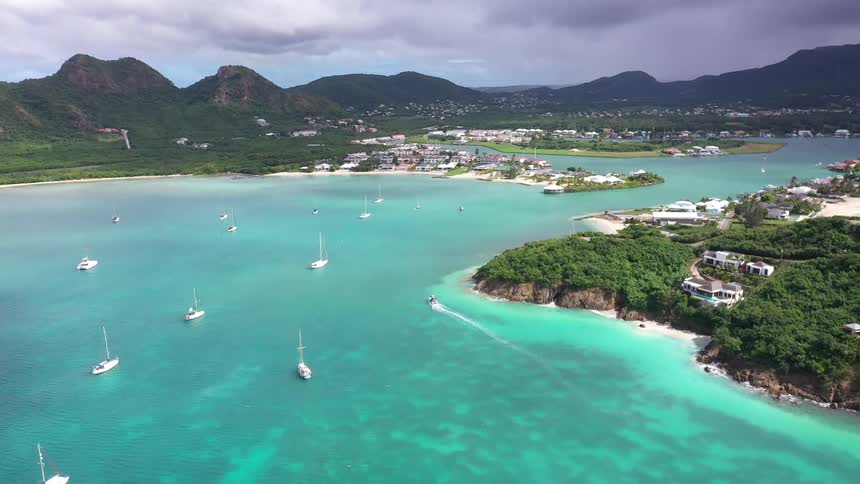 Yachts on an island with buildings on the shore