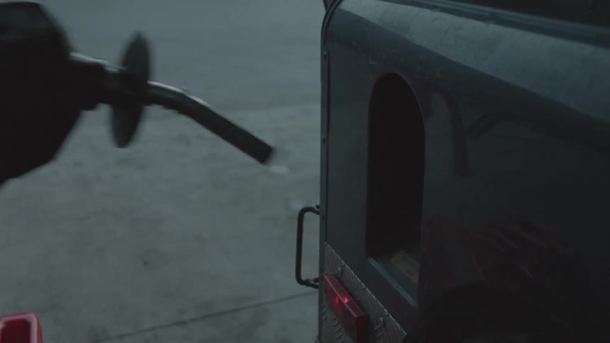 A person pumping gas