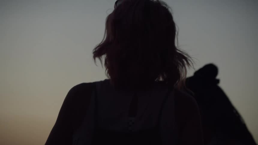 Silhouette of two people in an outdoor setting