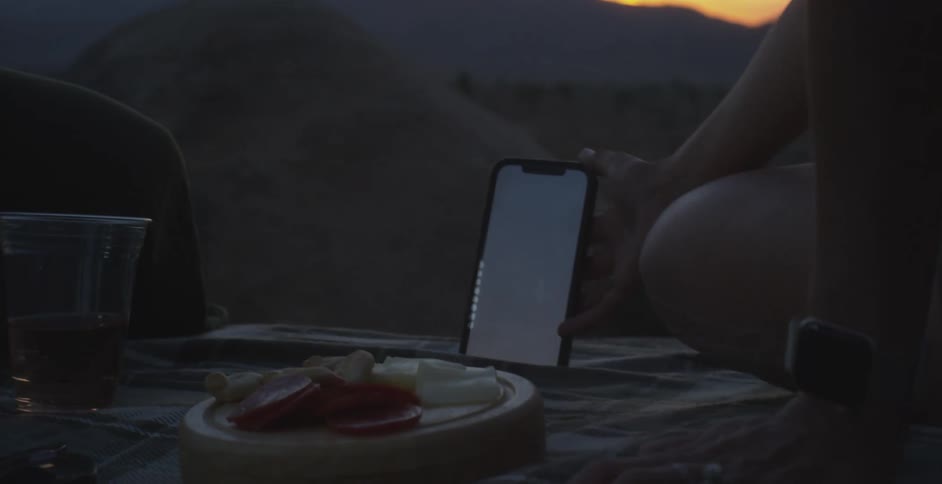 Two people are having a picnic on the sand