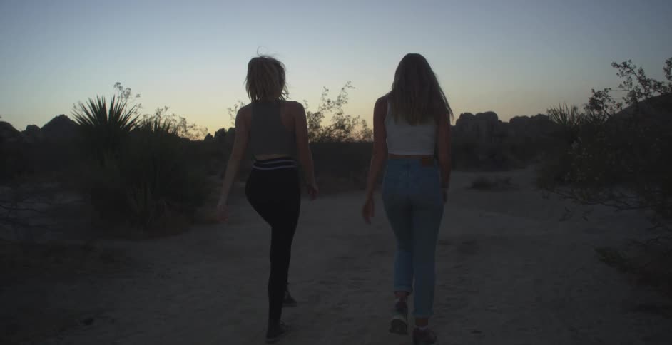 Two women are hiking in the desert